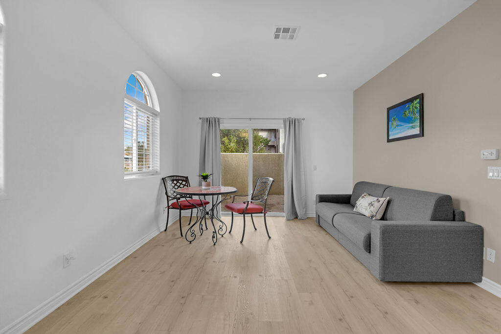 12622 Miracle Hill Road Desert Hot Springs, CA 92240 - Photo 101 of 124 a living room with furniture and a wooden floor