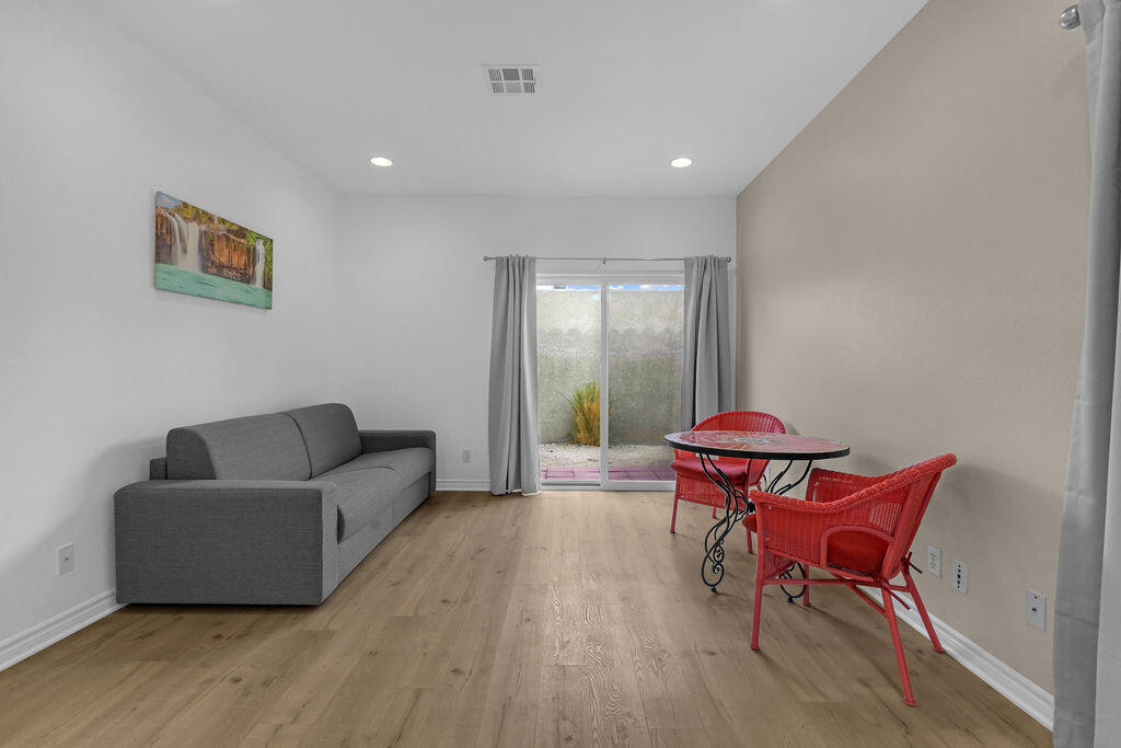 12622 Miracle Hill Road Desert Hot Springs, CA 92240 - Photo 102 of 124 a living room with furniture and a wooden floor