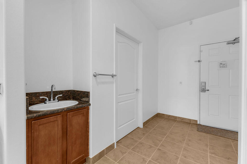 12622 Miracle Hill Road Desert Hot Springs, CA 92240 - Photo 112 of 124 a bathroom with a granite countertop sink and a mirror