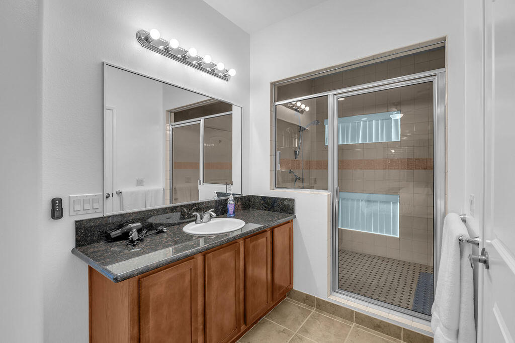 12622 Miracle Hill Road Desert Hot Springs, CA 92240 - Photo 117 of 124 a bathroom with a granite countertop sink and a mirror