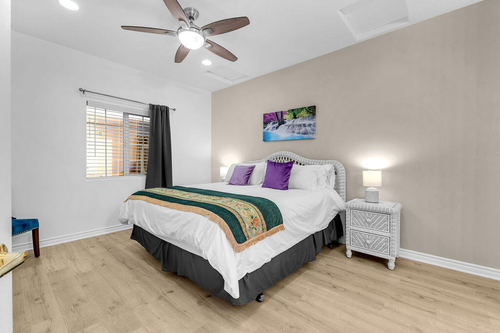 12622 Miracle Hill Road Desert Hot Springs, CA 92240 - Photo 120 of 124 a spacious bedroom with a bed and a chandelier