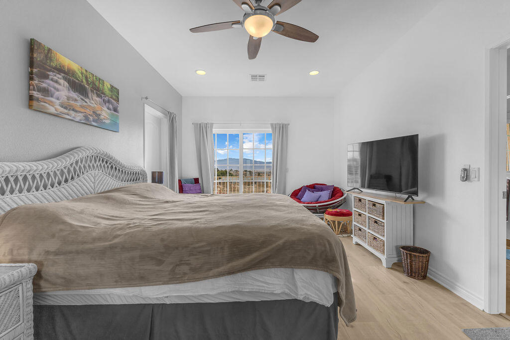 12622 Miracle Hill Road Desert Hot Springs, CA 92240 - Photo 16 of 124 a bedroom with a bed and a flat screen tv