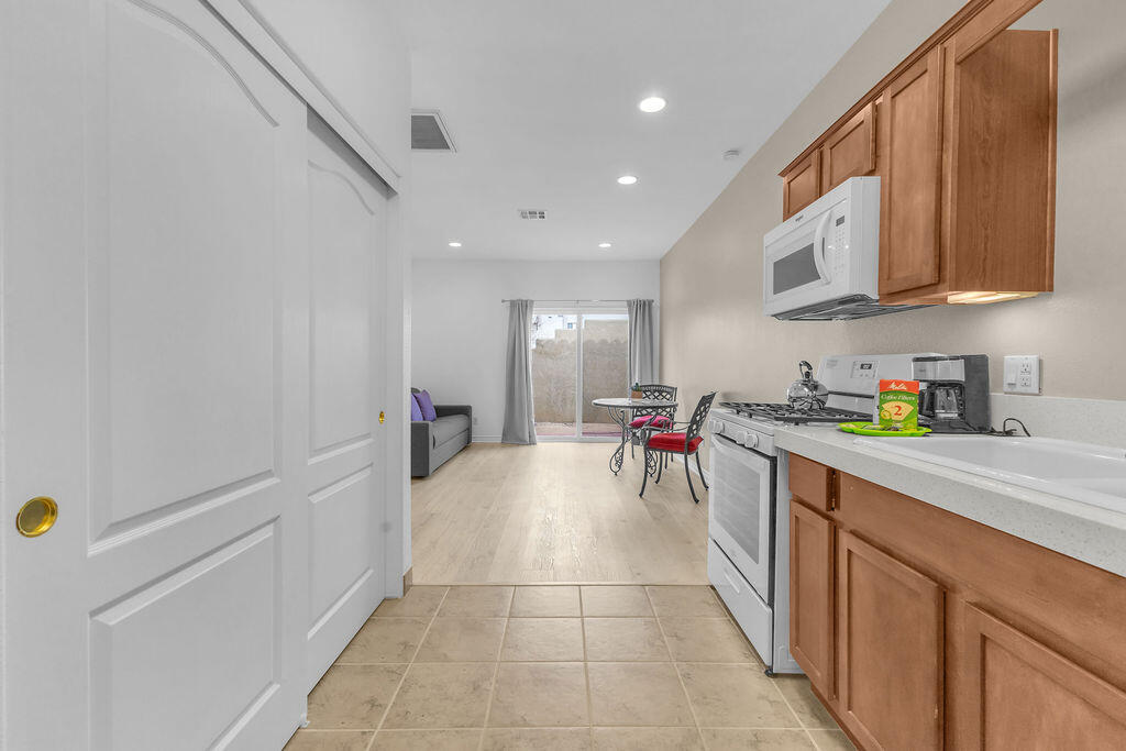 12622 Miracle Hill Road Desert Hot Springs, CA 92240 - Photo 19 of 124 a kitchen with stainless steel appliances granite countertop a sink and cabinets
