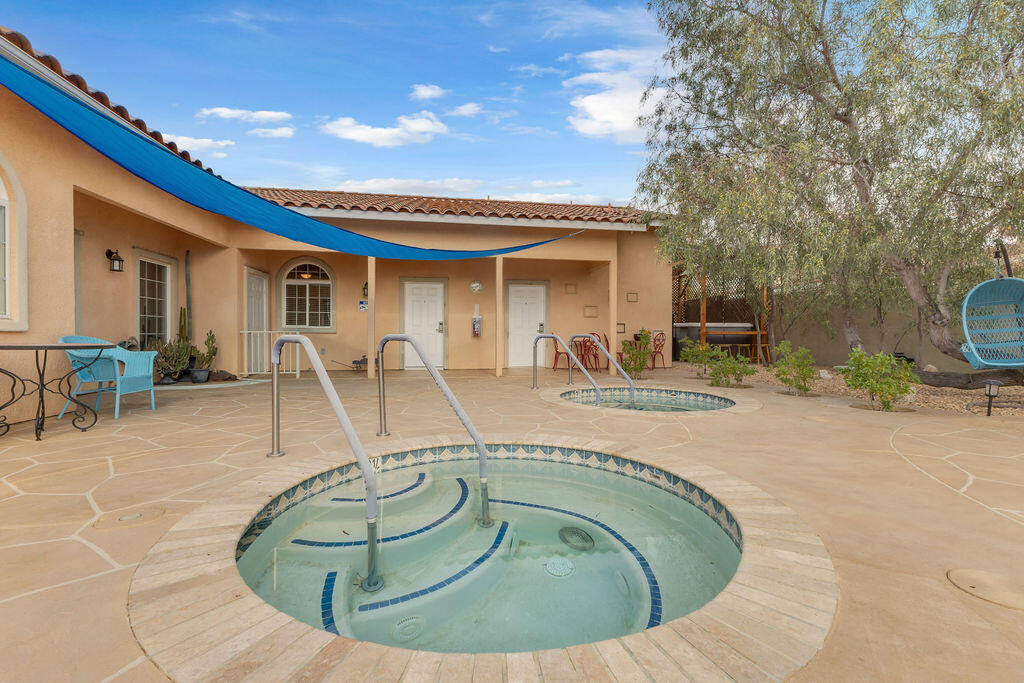 12622 Miracle Hill Road Desert Hot Springs, CA 92240 - Photo 3 of 124 a view of a swimming pool with outdoor seating