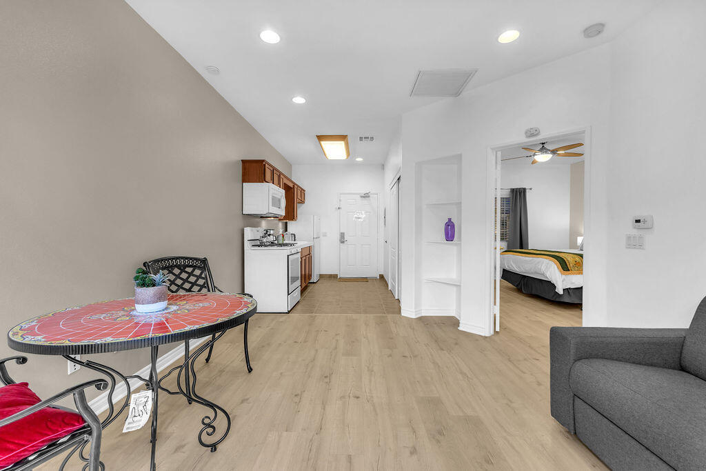 12622 Miracle Hill Road Desert Hot Springs, CA 92240 - Photo 31 of 124 a living room with furniture and a wooden floor