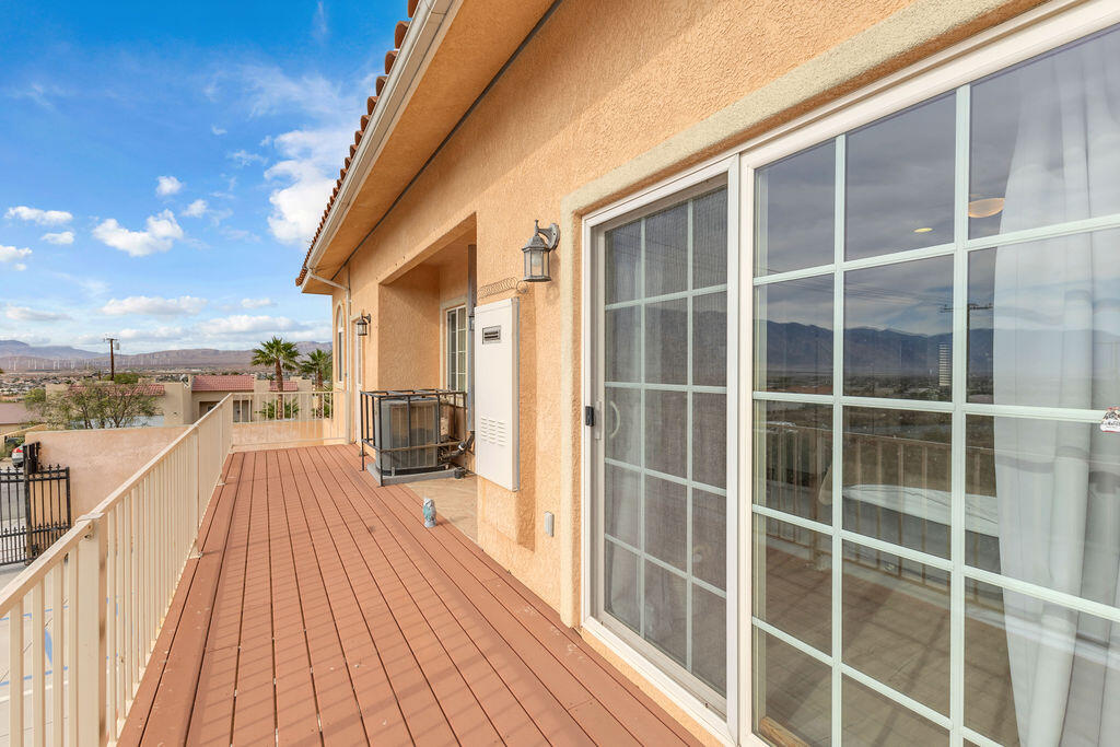 12622 Miracle Hill Road Desert Hot Springs, CA 92240 - Photo 52 of 124 a view of a balcony with wooden floor and fence