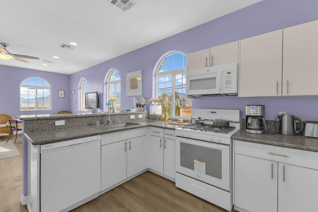 12622 Miracle Hill Road Desert Hot Springs, CA 92240 - Photo 56 of 124 a kitchen with granite countertop a sink stove and cabinets