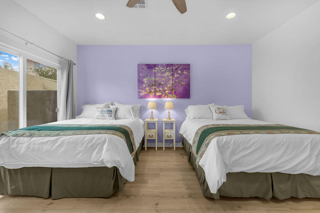 12622 Miracle Hill Road Desert Hot Springs, CA 92240 - Photo 62 of 124 a bedroom with two beds and a large window