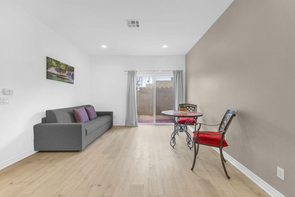 12622 Miracle Hill Road Desert Hot Springs, CA 92240 - Photo 63 of 124 a living room with furniture and a wooden floor