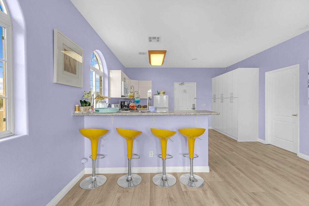 12622 Miracle Hill Road Desert Hot Springs, CA 92240 - Photo 90 of 124 a view of a dining room with furniture and wooden floor