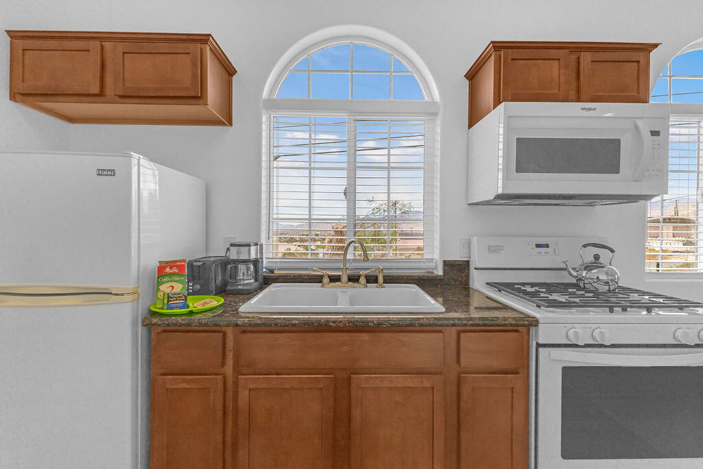 12622 Miracle Hill Road Desert Hot Springs, CA 92240 - Photo 94 of 124 a kitchen with stainless steel appliances granite countertop a sink a stove and a refrigerator