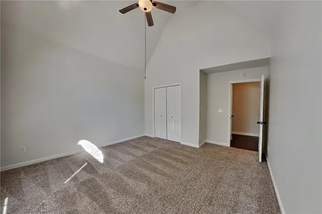 a bedroom with a bed and a chandelier fan