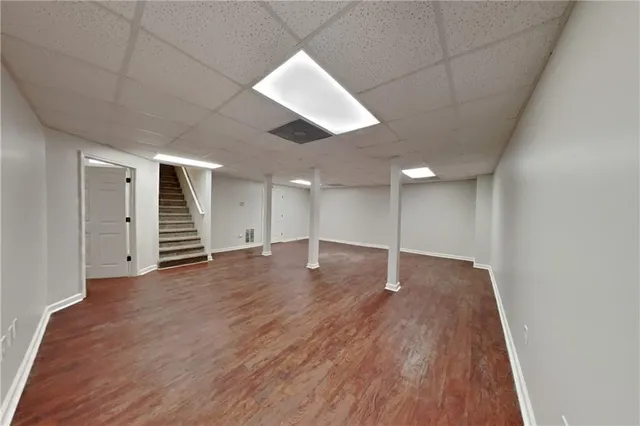 an empty room with wooden floor and closet