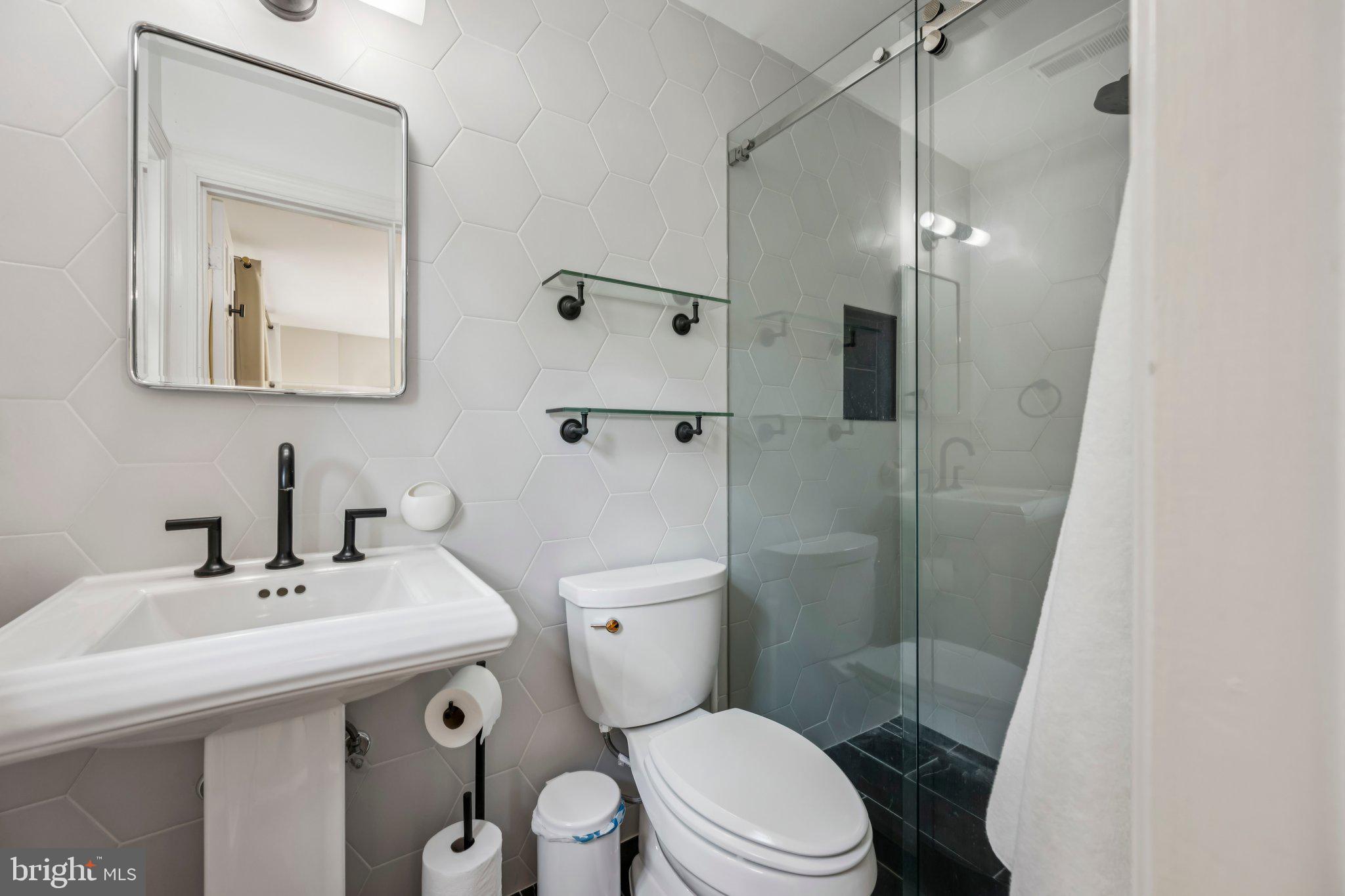 5109 River Hill Road Bethesda, MD 20816 - Photo 19 of 21 a bathroom with a sink toilet and shower