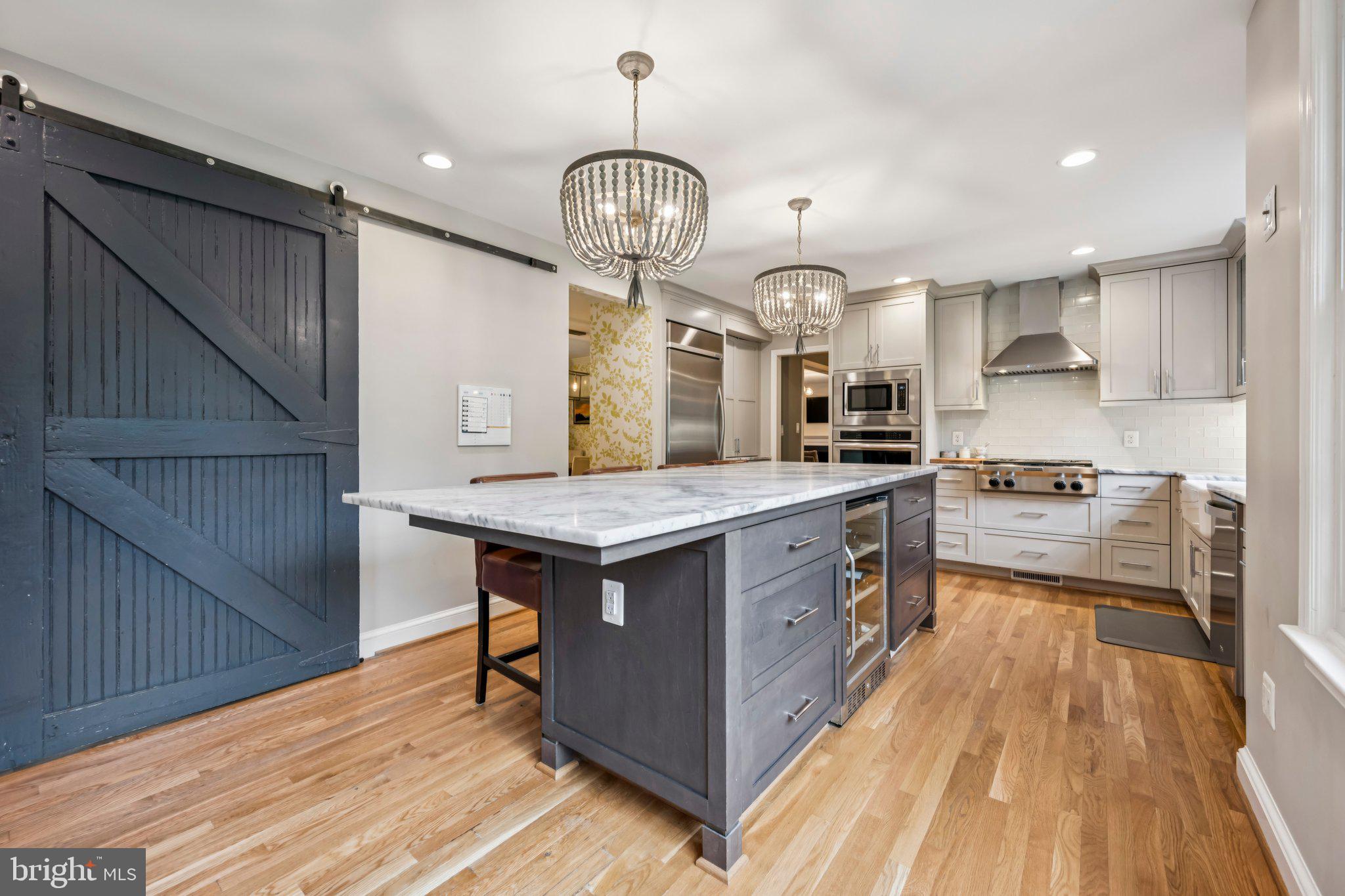 5109 River Hill Road Bethesda, MD 20816 - Photo 2 of 21 a kitchen with granite countertop a stove and a wooden floors