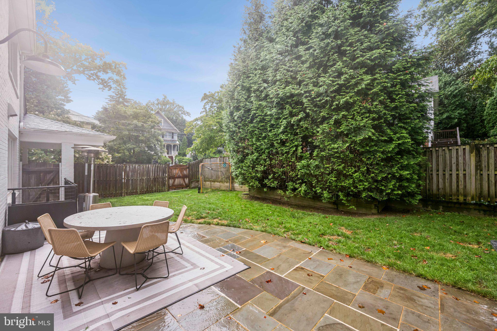 5109 River Hill Road Bethesda, MD 20816 - Photo 21 of 21 a view of a patio with table and chairs potted plants with wooden fence
