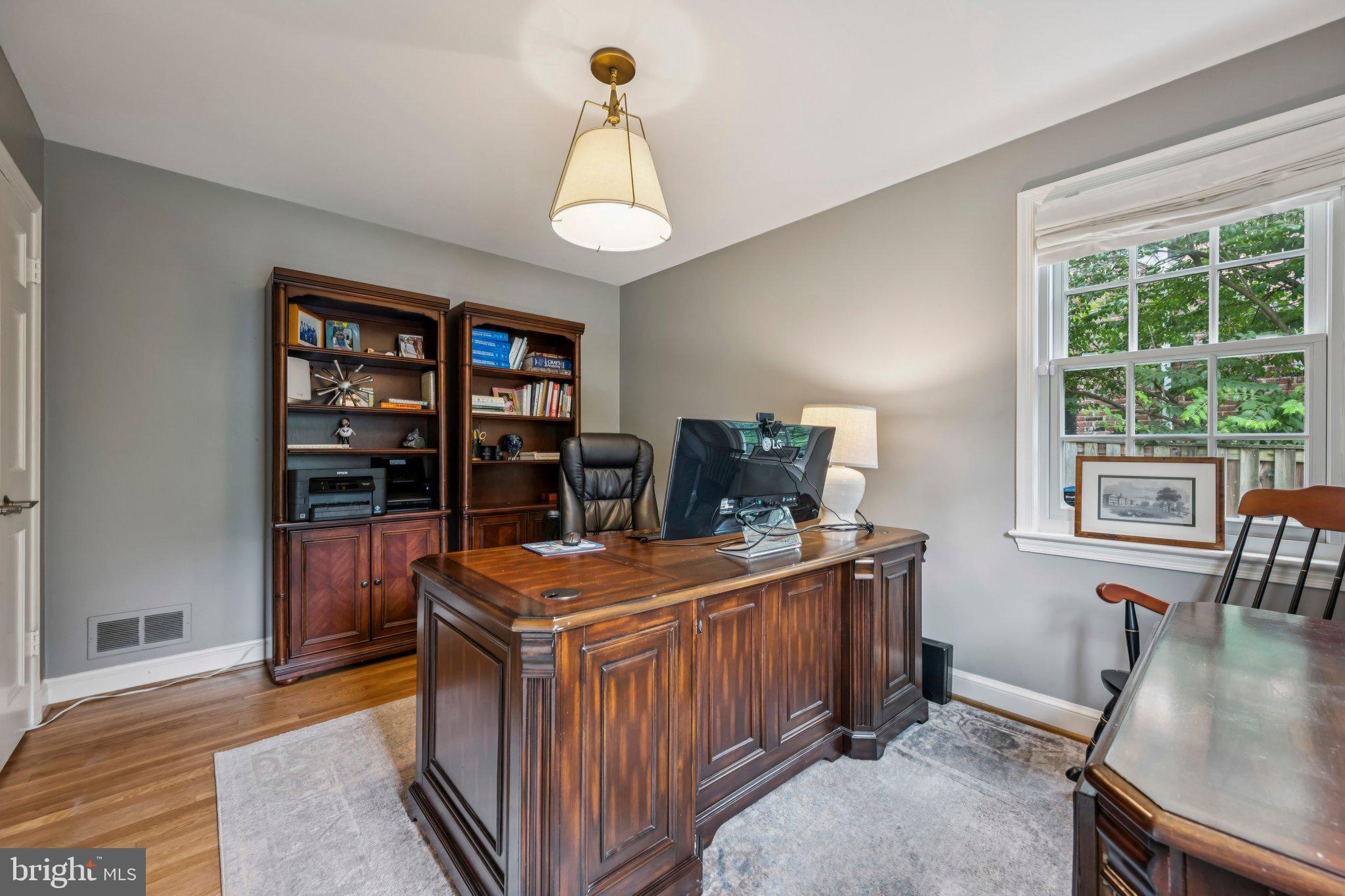 5109 River Hill Road Bethesda, MD 20816 - Photo 9 of 21 a room with furniture a bookshelf and a window
