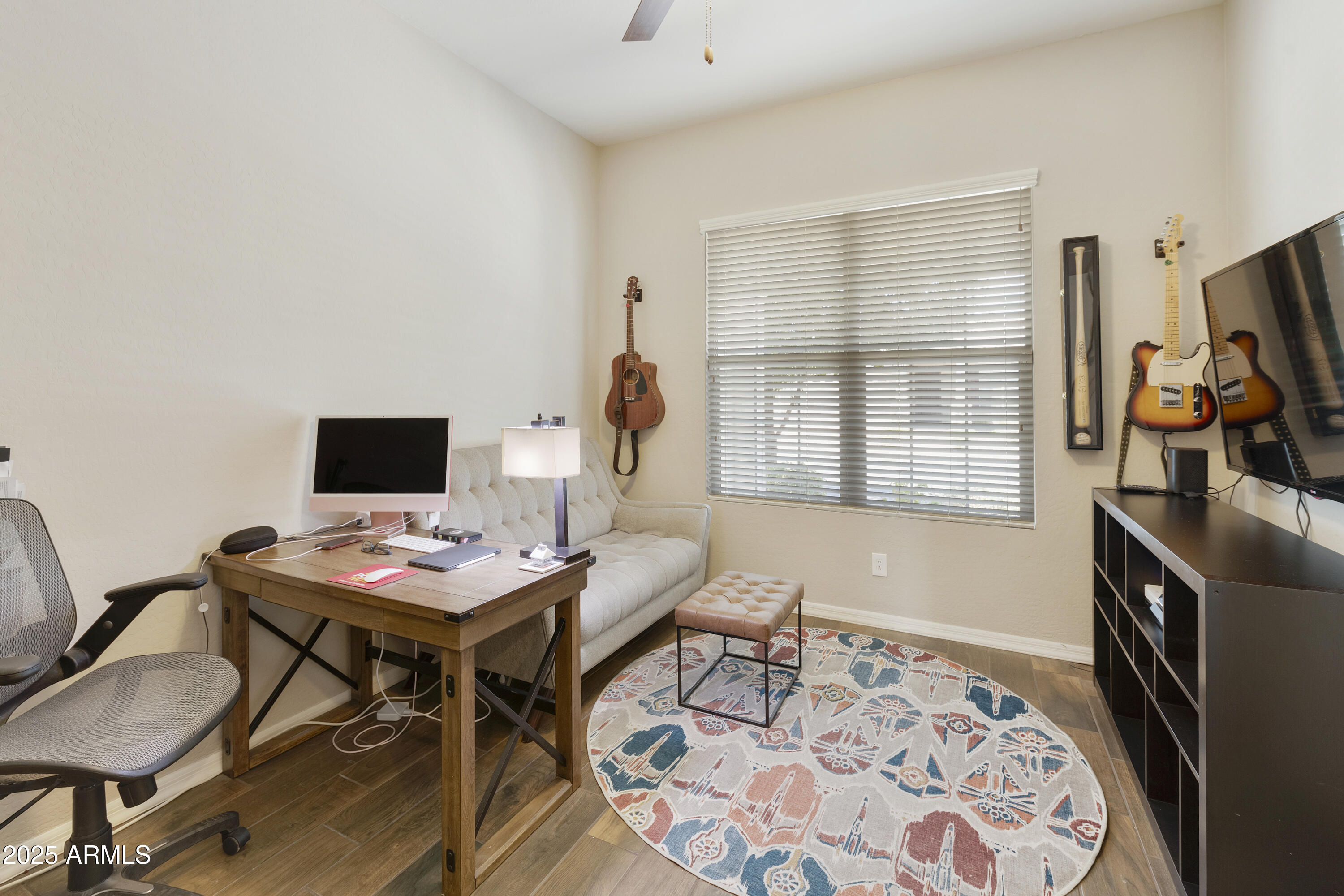 1517 West Redondo Drive Gilbert, AZ 85233 - Photo 27 of 55 a workspace with furniture and a flat screen tv