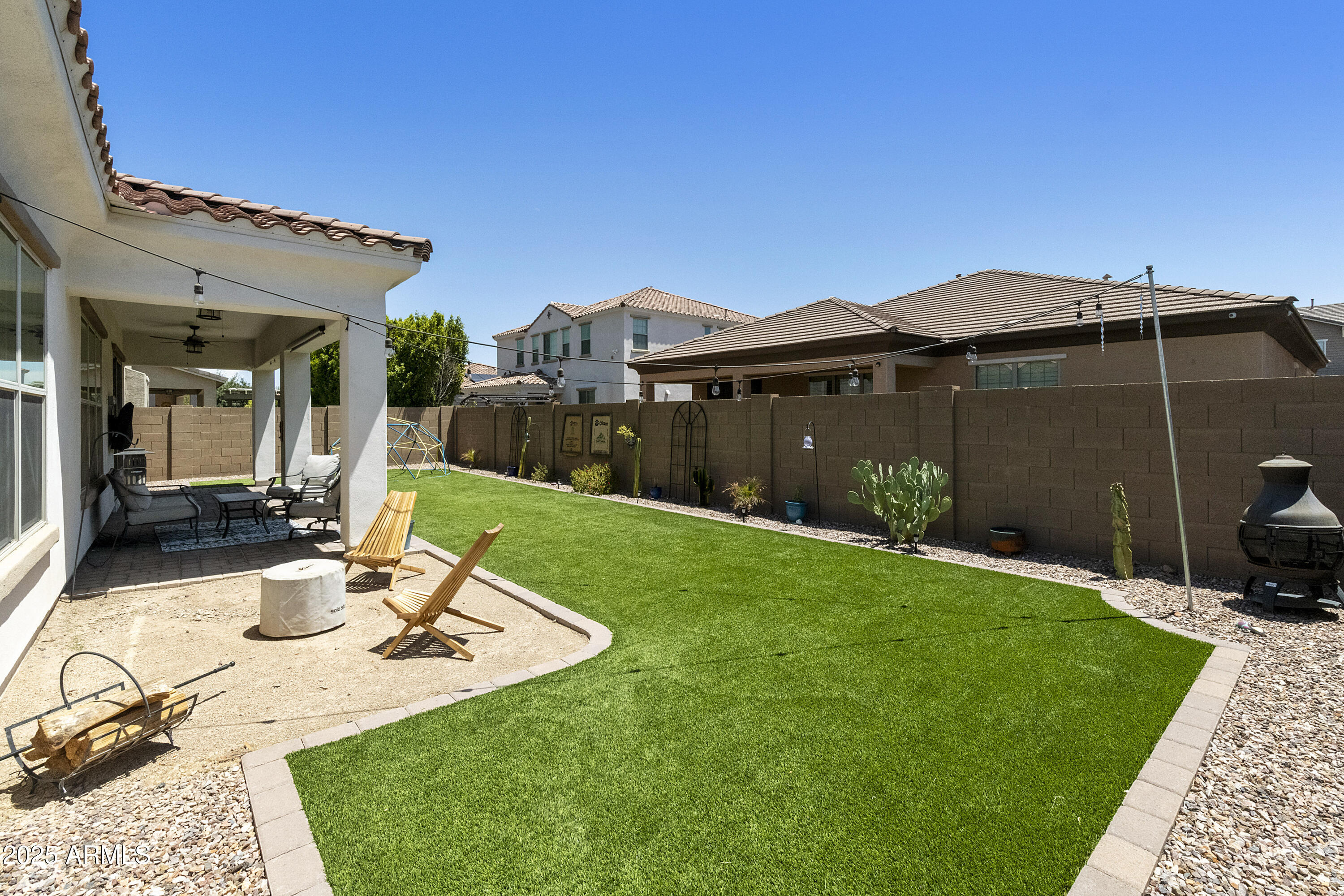 1517 West Redondo Drive Gilbert, AZ 85233 - Photo 35 of 55 a view of a patio with a dining table and chairs under an umbrella