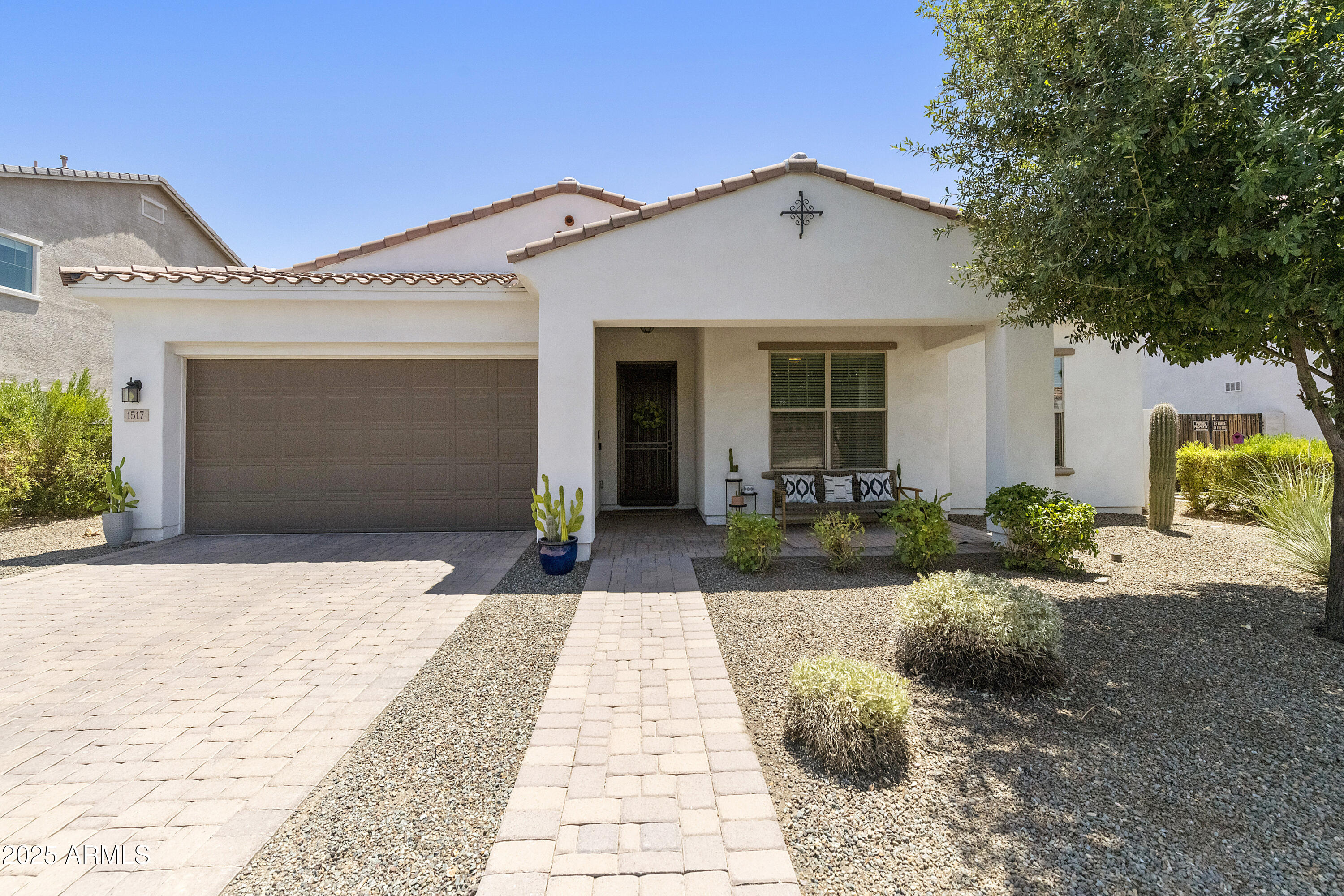 1517 West Redondo Drive Gilbert, AZ 85233 - Photo 43 of 55 a front view of a house with a yard and potted plants