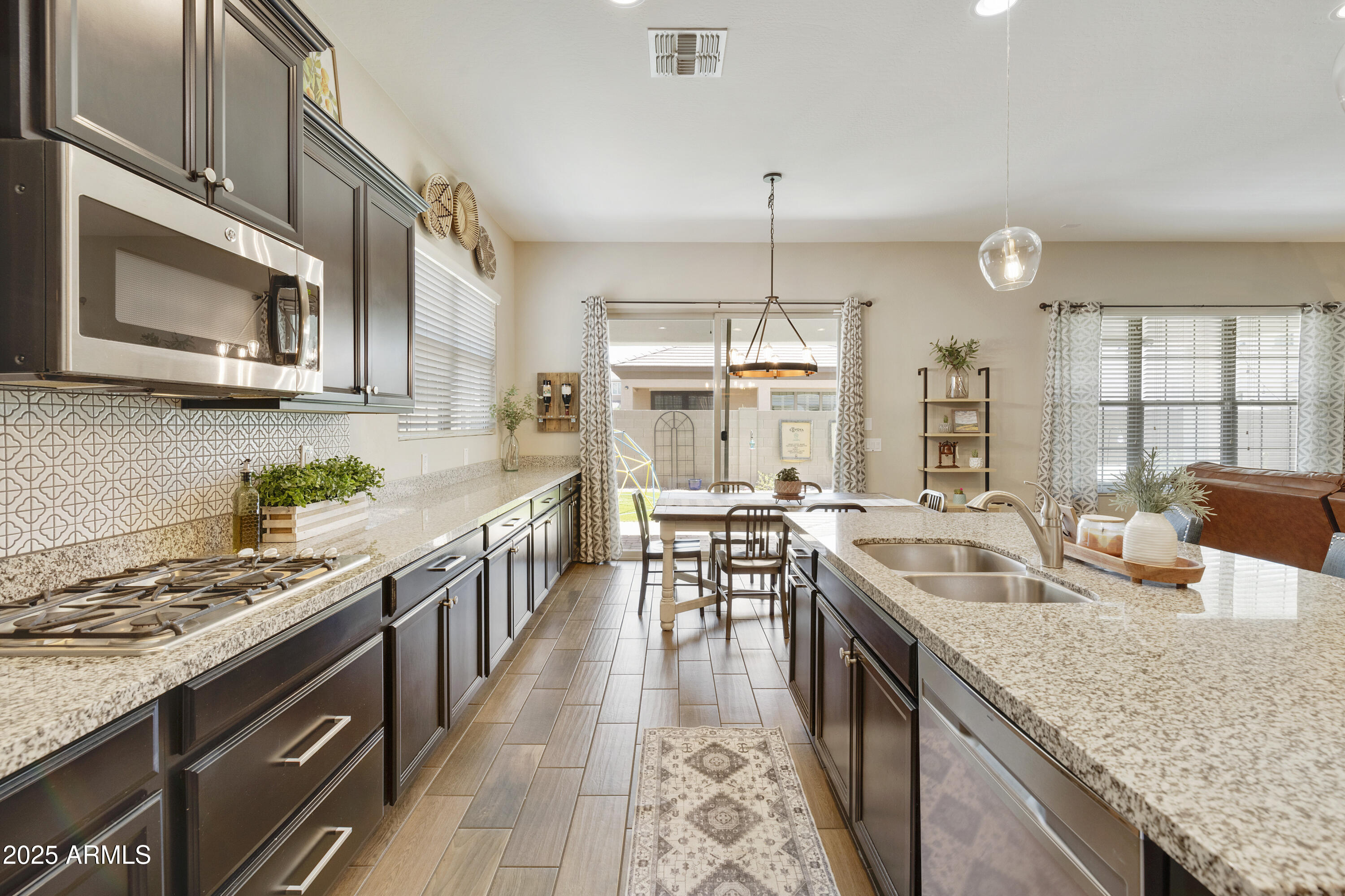 1517 West Redondo Drive Gilbert, AZ 85233 - Photo 6 of 55 a kitchen with stainless steel appliances granite countertop a sink stove and refrigerator