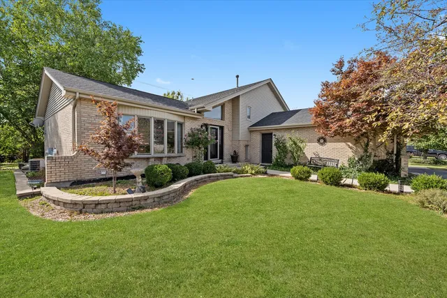 a front view of house with a garden and patio