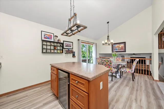 a kitchen with a table chairs and wooden floor