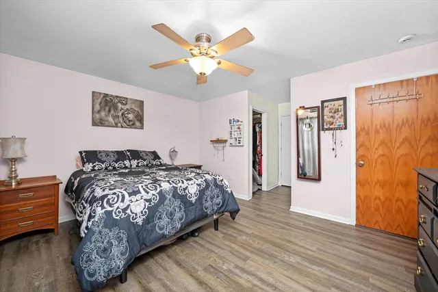 a bedroom with a large bed and a chandelier