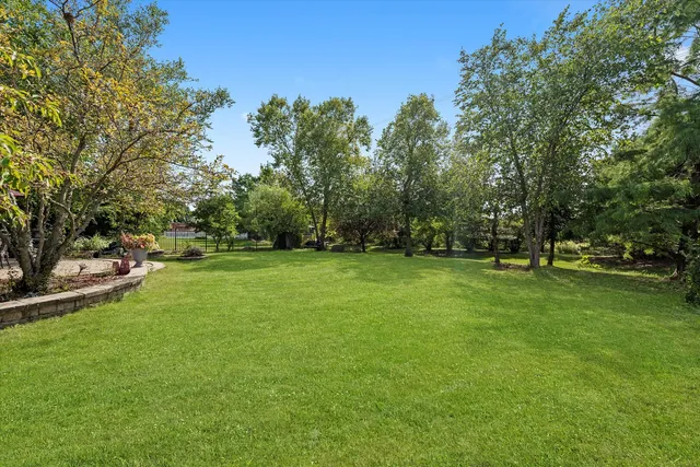 a swimming pool with outdoor seating and yard