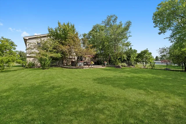 an aerial view of a house with yard swimming pool and outdoor seating