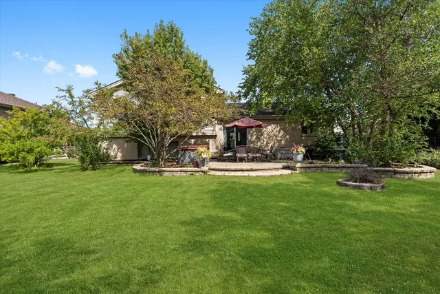 an aerial view of a house with a yard basket ball court and outdoor seating