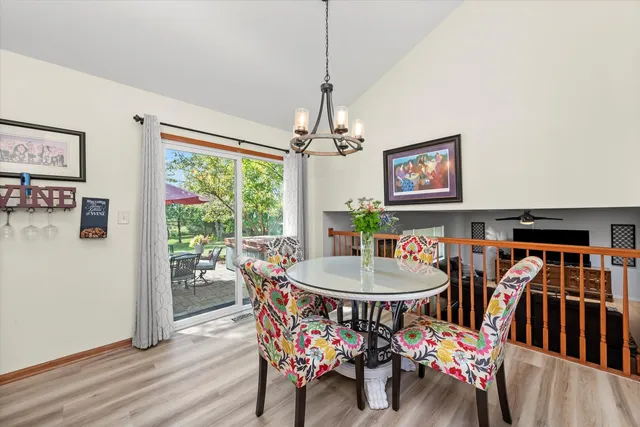 a dining room with furniture a rug and wooden floor