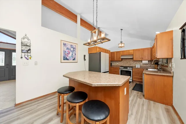 a kitchen that has a table and chairs in it