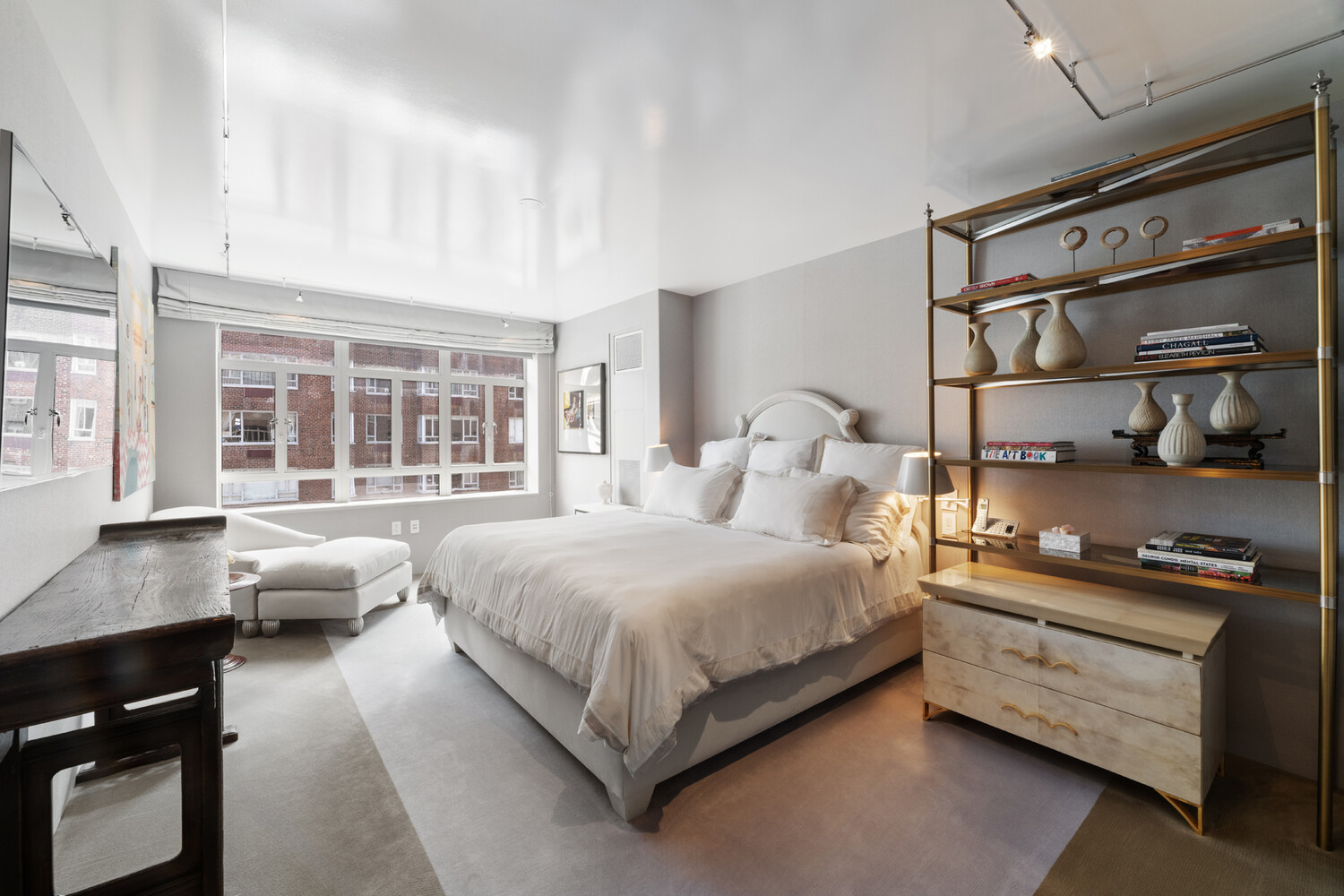 21 East 61st Street, Unit 8F Manhattan, NY 10065 - Photo 11 of 23 a bedroom with a bed and wooden floor