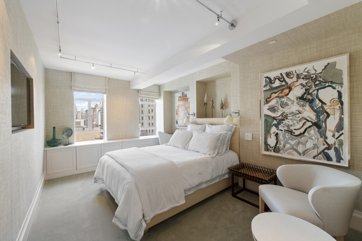 21 East 61st Street, Unit 8F Manhattan, NY 10065 - Photo 13 of 23 a bedroom with a large bed couch and windows