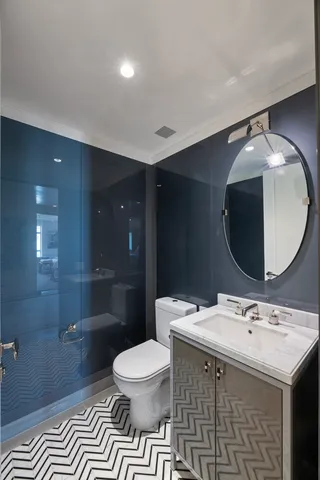 a bathroom with a double vanity sink mirror and toilet