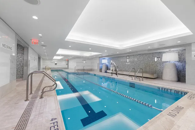 a living room with furniture a fireplace and a chandelier