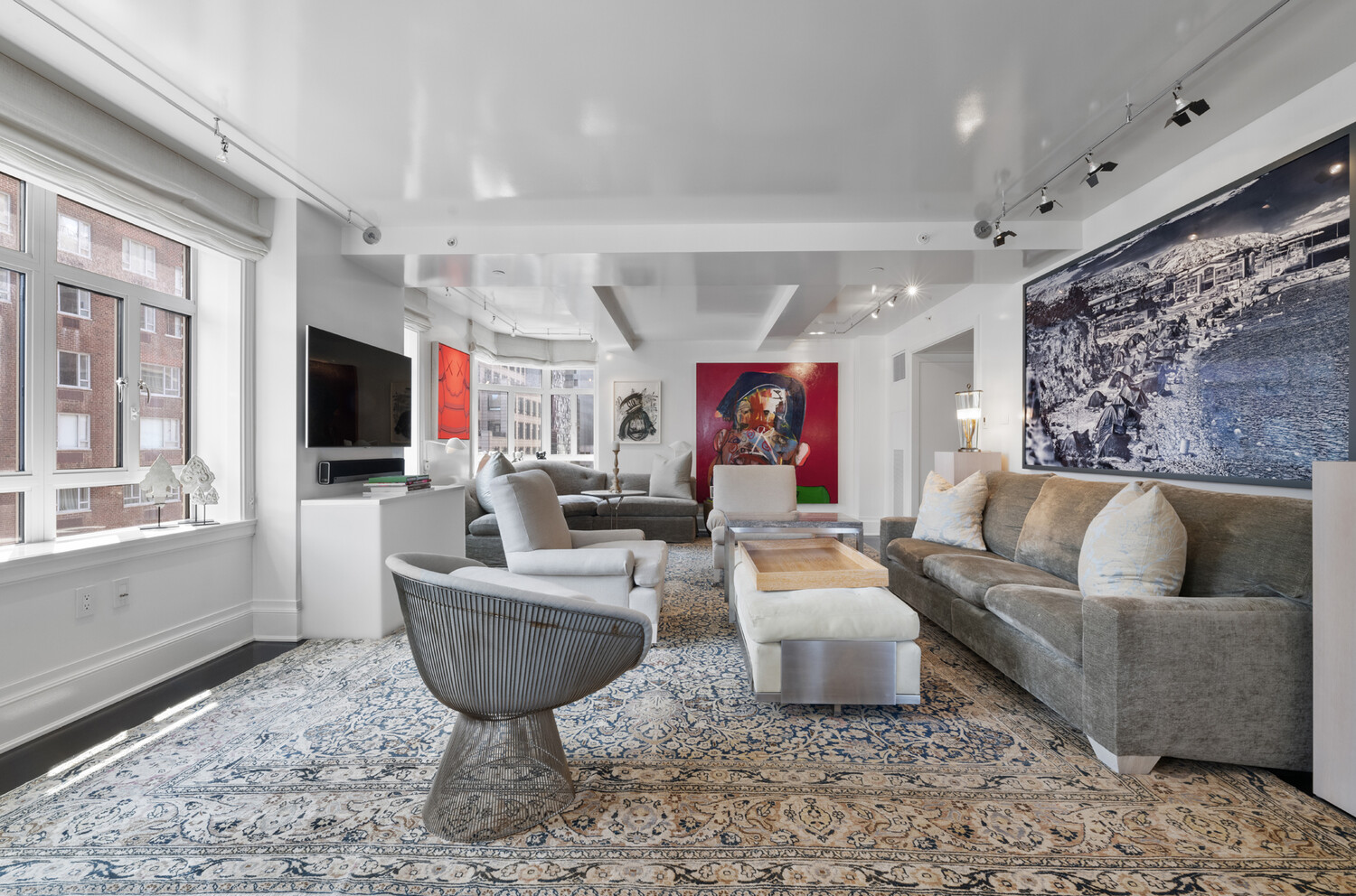 21 East 61st Street, Unit 8F Manhattan, NY 10065 - Photo 2 of 23 a living room with furniture and a flat screen tv