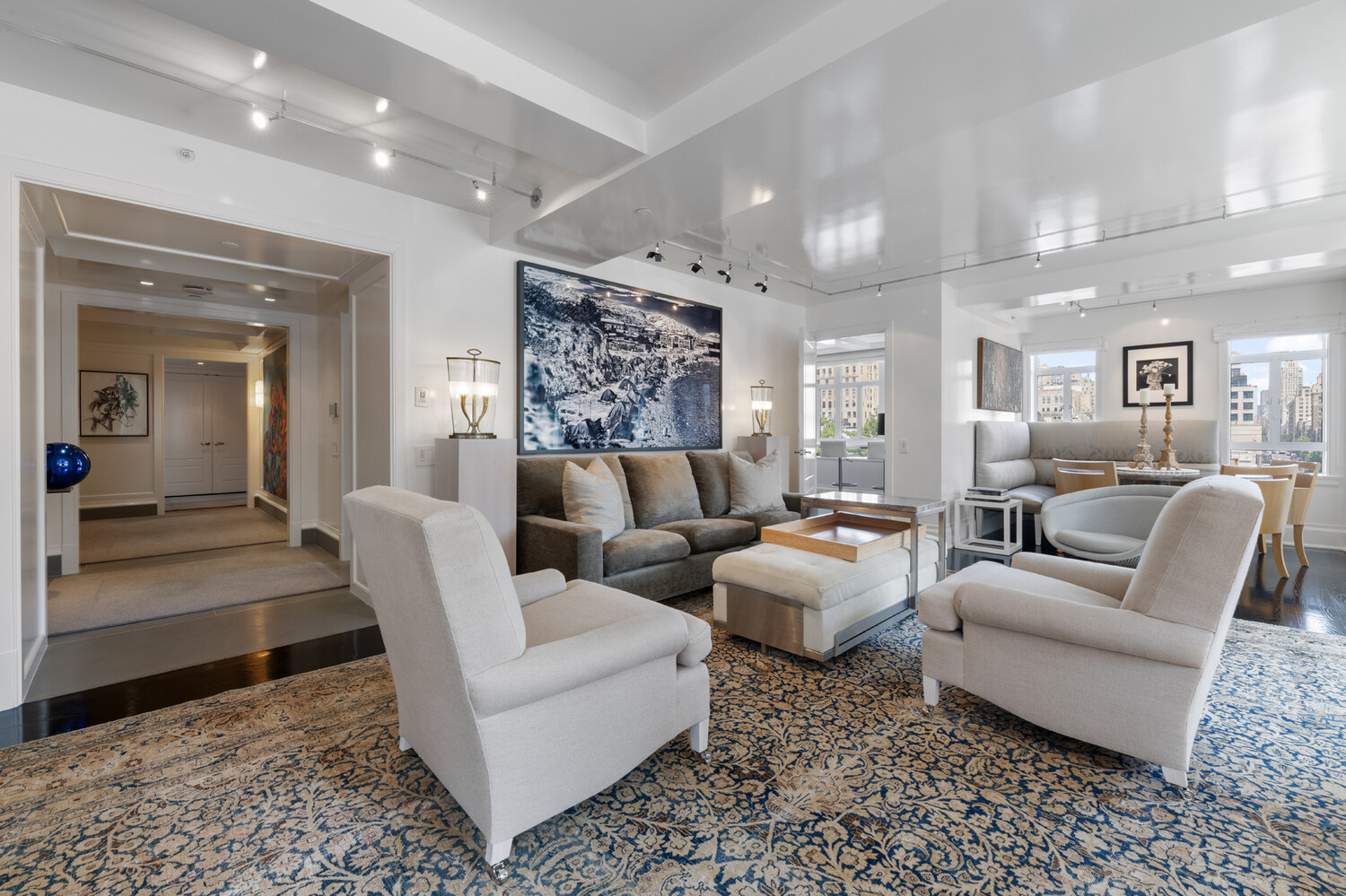 21 East 61st Street, Unit 8F Manhattan, NY 10065 - Photo 3 of 23 a living room with furniture and a large mirror