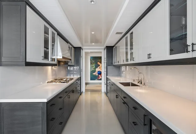 a large kitchen with stainless steel appliances and a sink