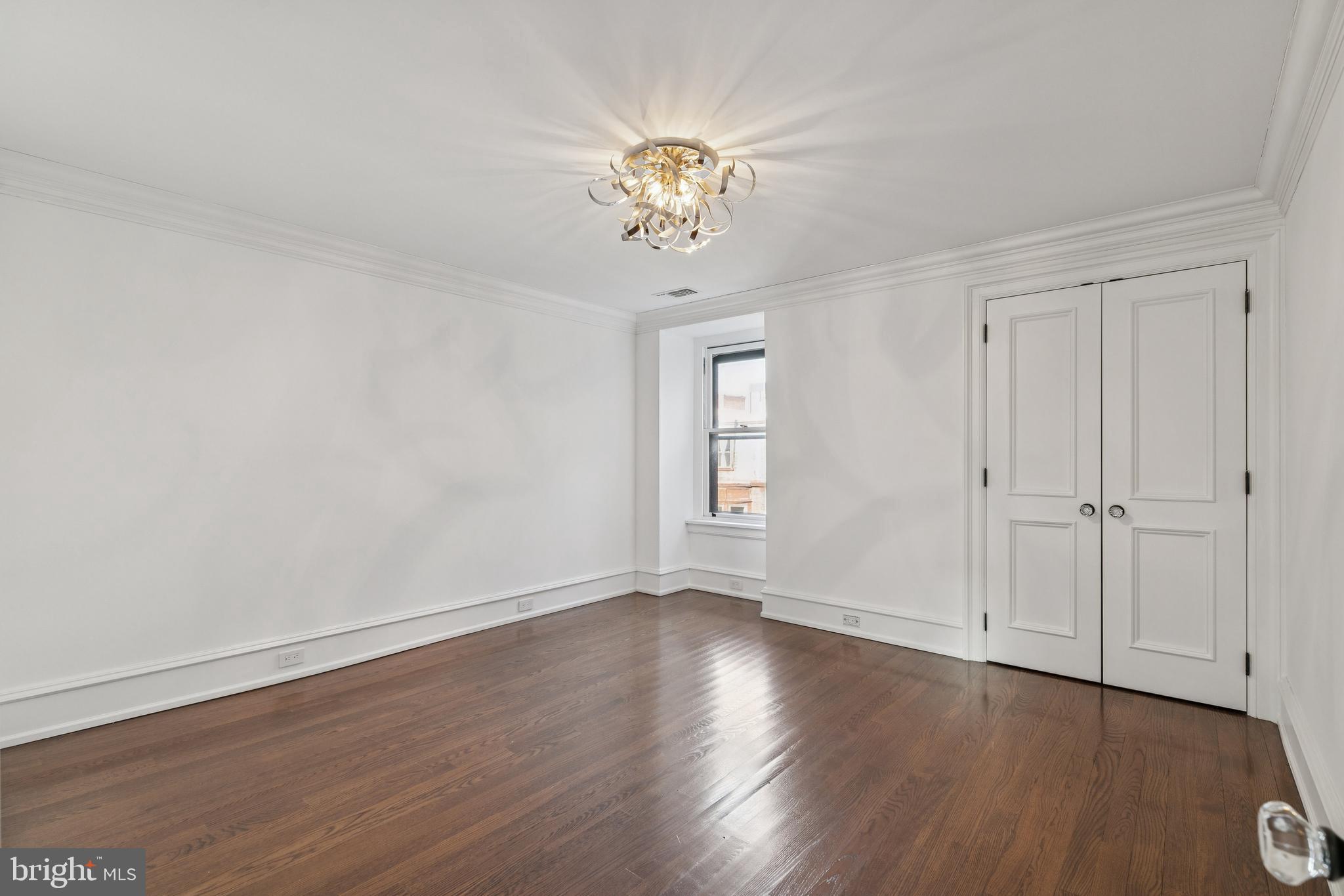2015 Delancey Place Philadelphia, PA 19103 - Photo 31 of 38 a view of an empty room with wooden floor and a window