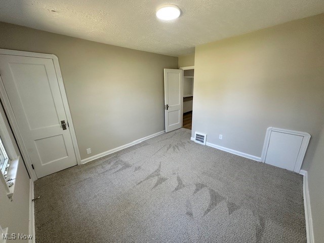 26203 Tryon Road Bedford, OH 44146 - Photo 9 of 18 Spare room featuring light colored carpet and a textured ceiling
