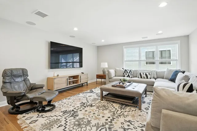 a living room with furniture wooden floor and a flat screen tv