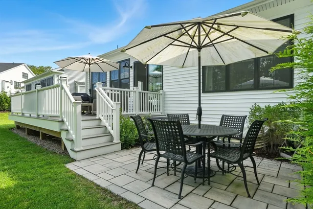 a view of a house with backyard and sitting area