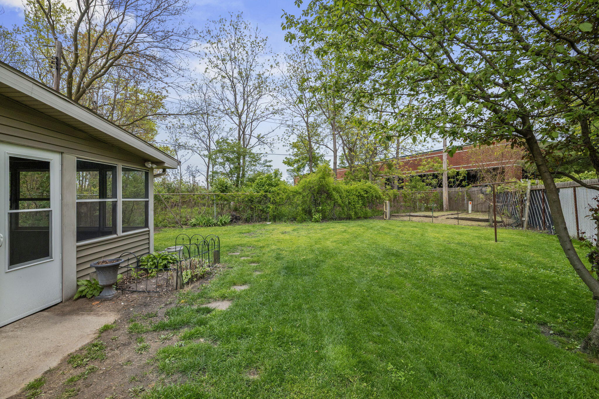 218 West 38th Court Griffith, IN 46319 - Photo 21 of 23 a view of a backyard with plants and large trees