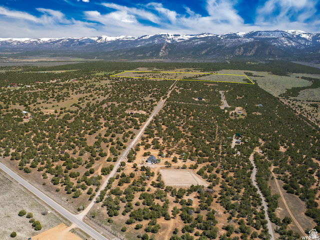 Aerial view of sparsely populated area with a mountain backdrop and property boundaries highlighted