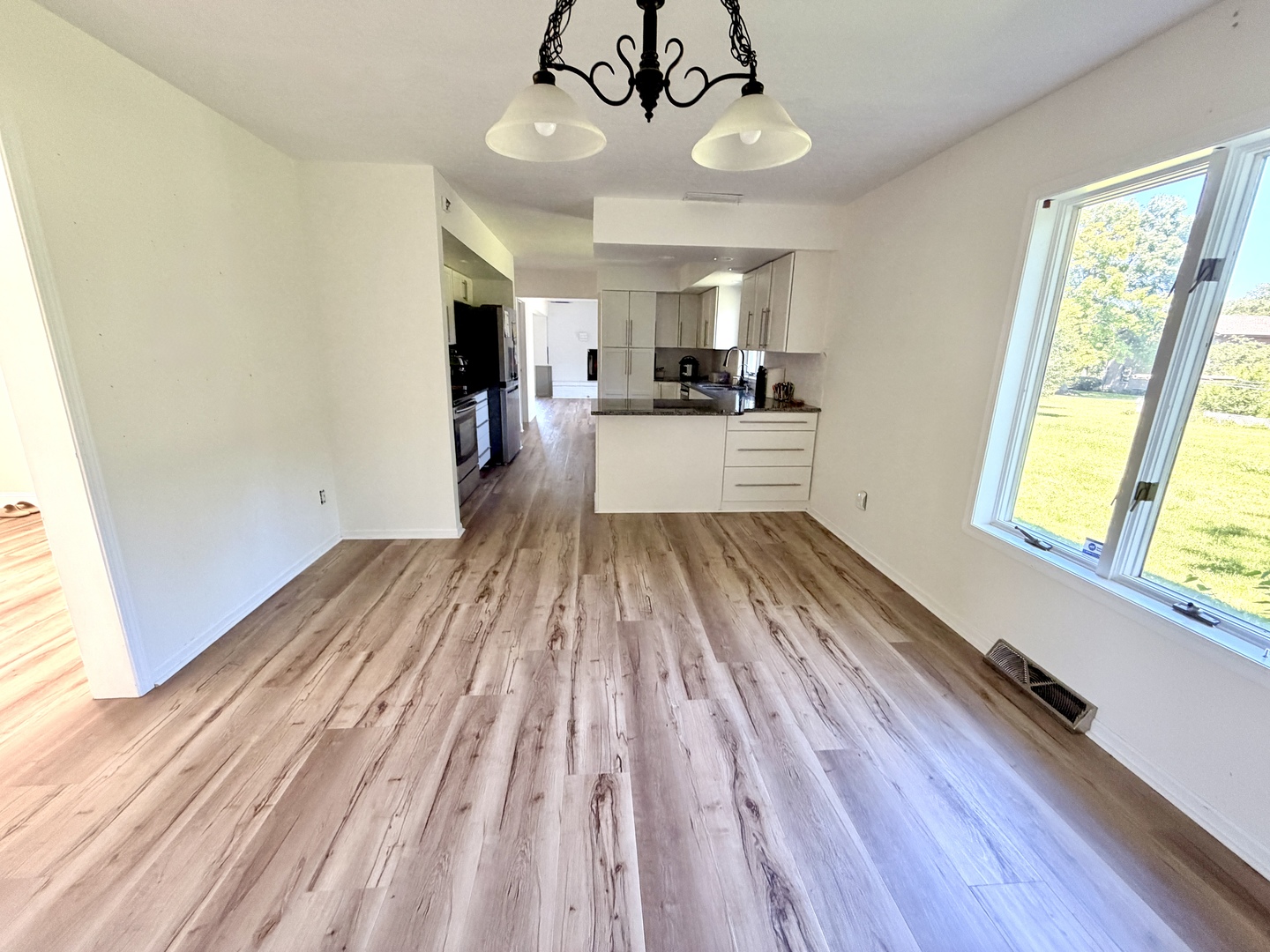 120 Grandin Road Morris, IL 60450 - Photo 10 of 38 a view of a kitchen with wooden floor and stainless steel appliances