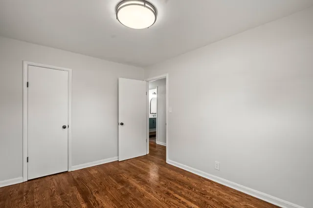 a view of an empty room and wooden floor