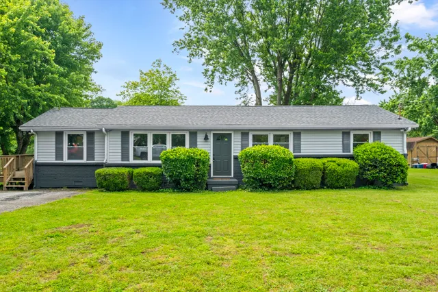 a view of a house with a yard and plants