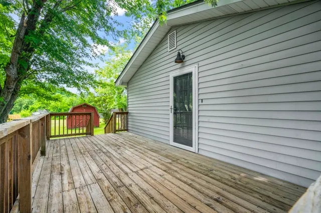a view of backyard with a deck